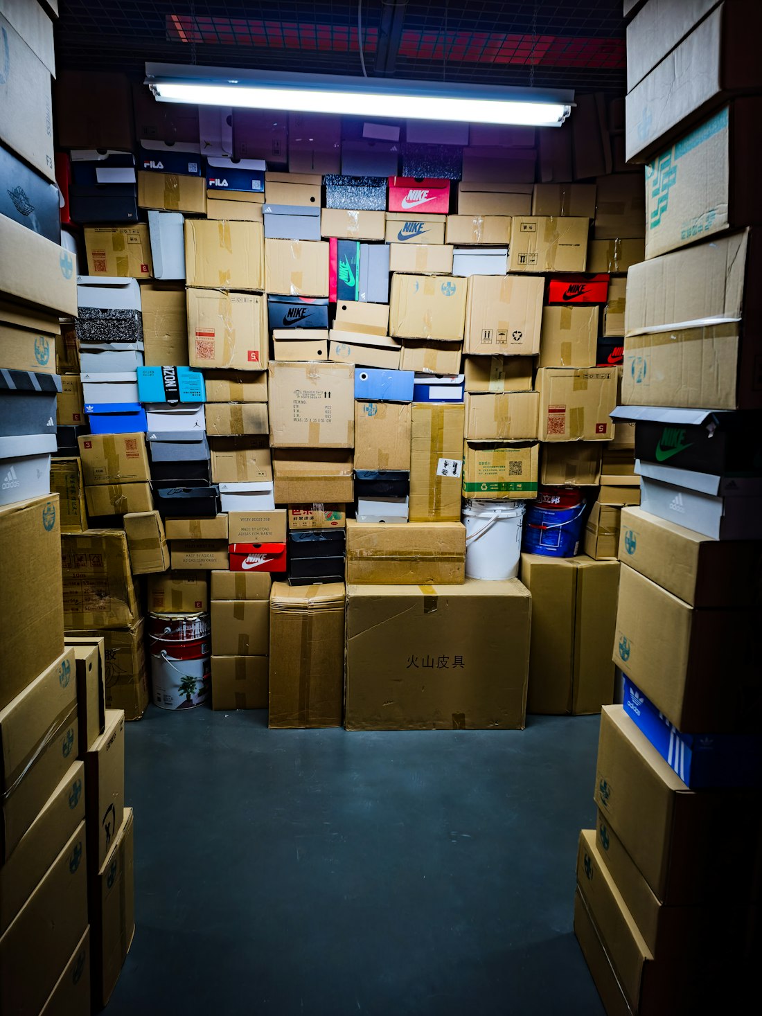 A room filled with many stacked cardboard boxes